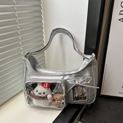 Silver ita bag with plushies in the clear window