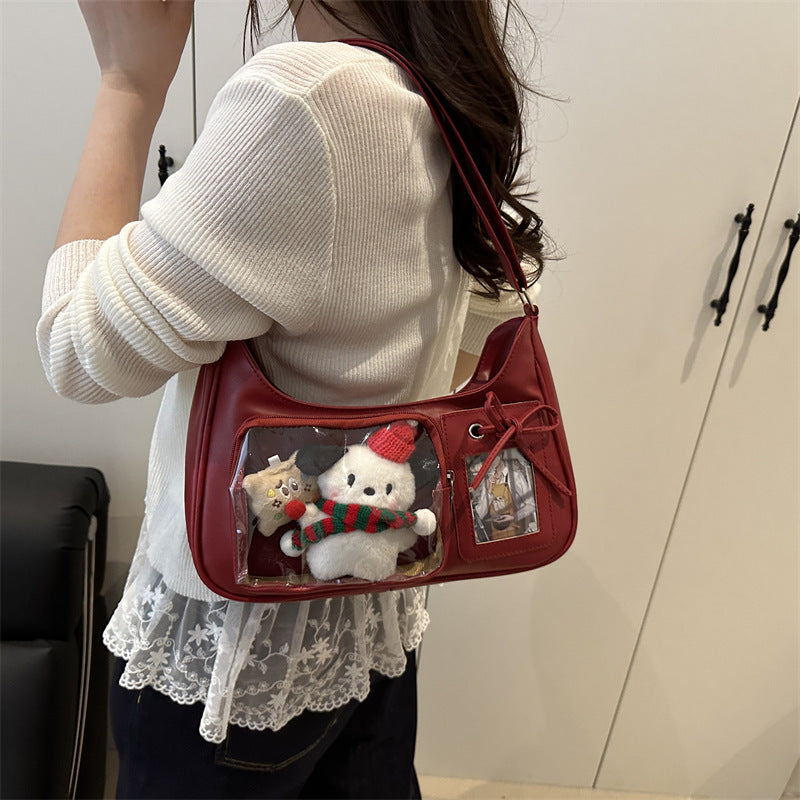 Red ita underarm bag worn with plush in the clear window